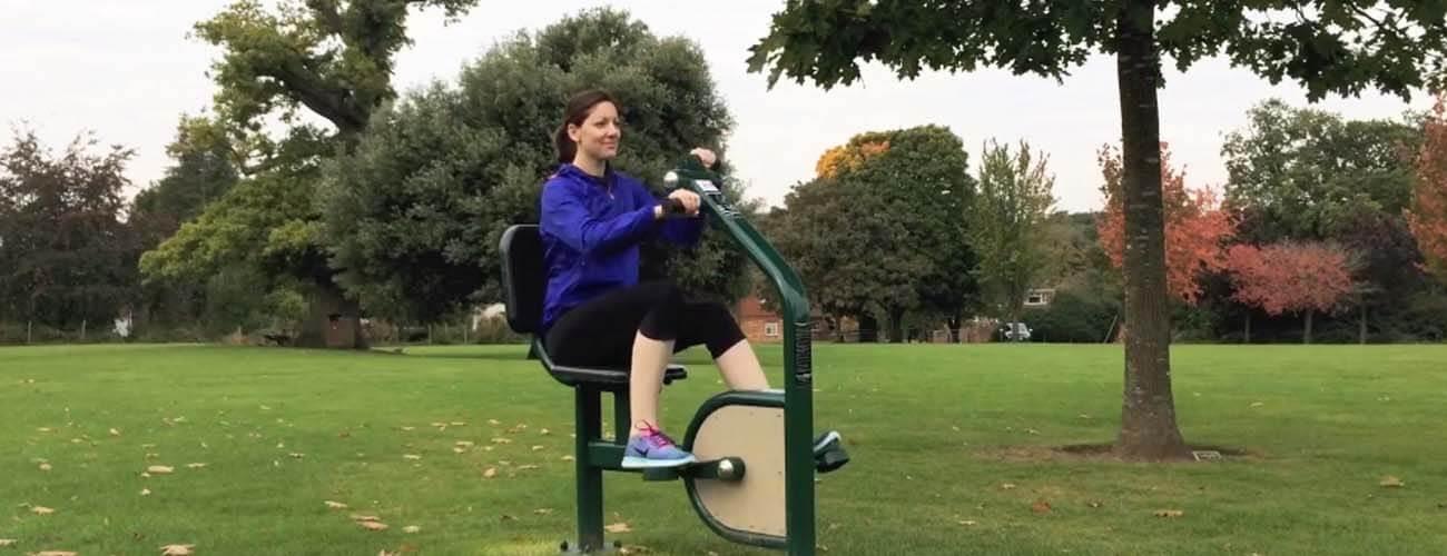 lady using fresh air fitness arm and pedal bike