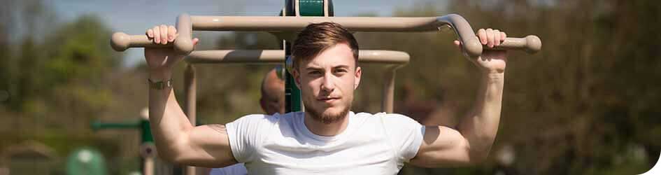 Man exercising outdoors on Fresh Air Fitness equipment