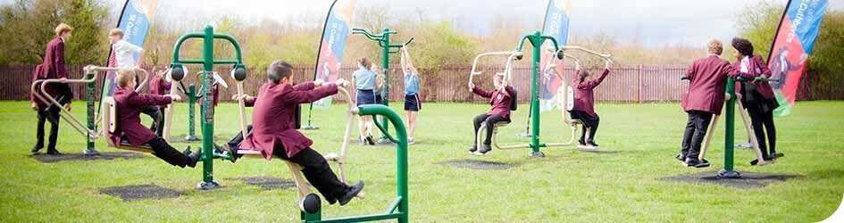 Students exercising on Fresh Air Fitness gym equipment for schools