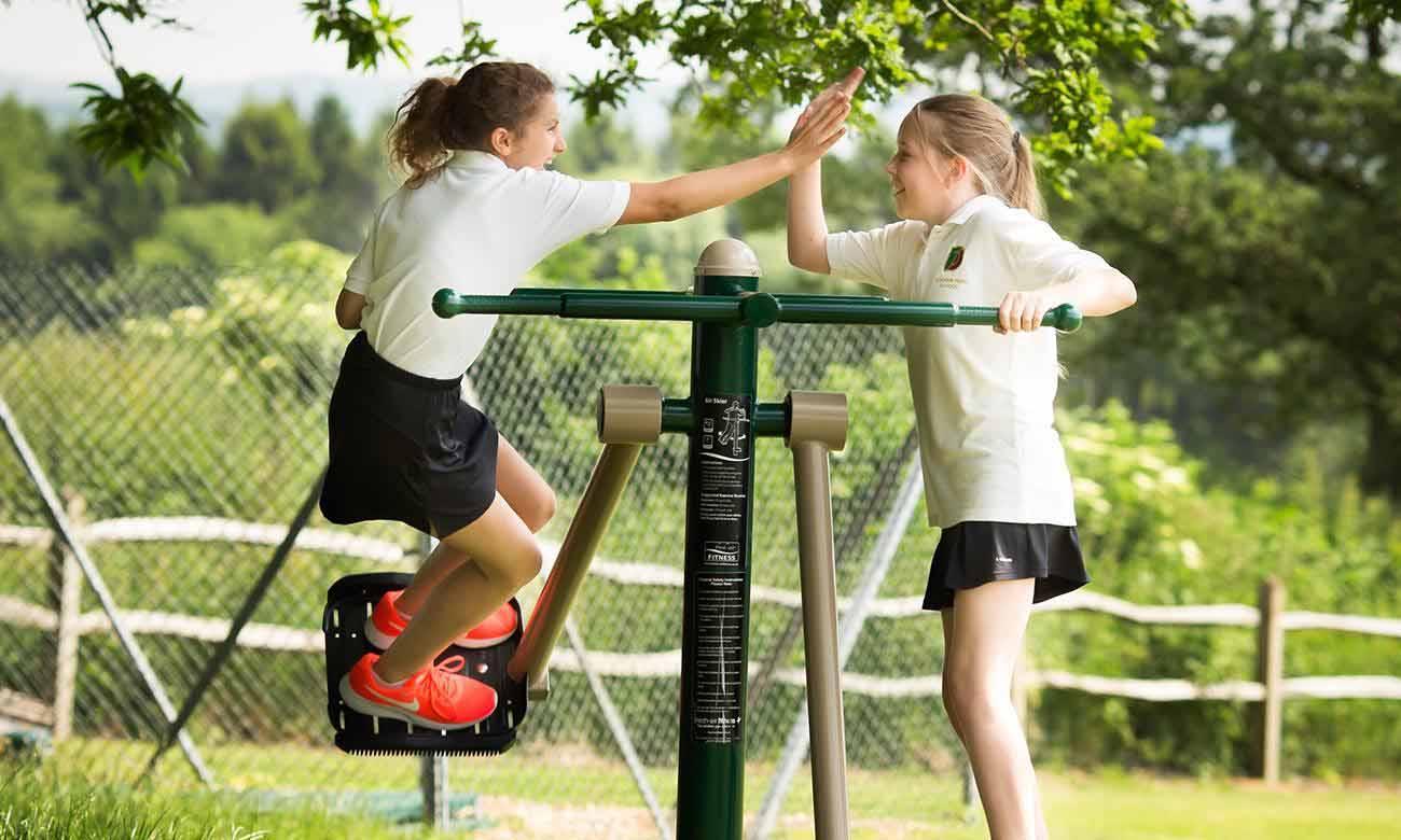 Teenage Girls on Fresh Air Fitness Outdoor Gym Equipment for Schools