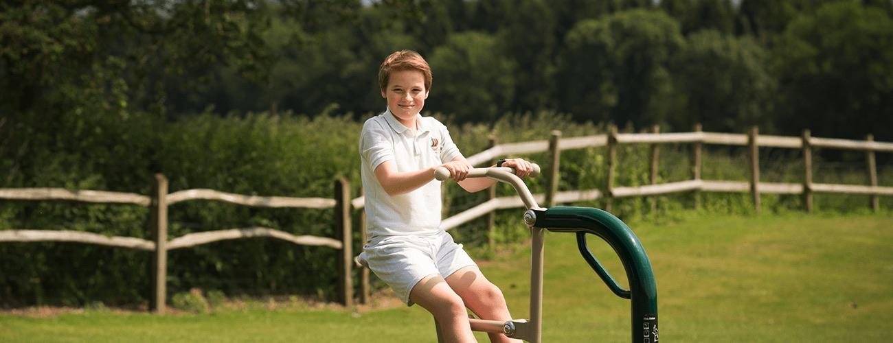 Children using outdoor gym equipment for secondary schools