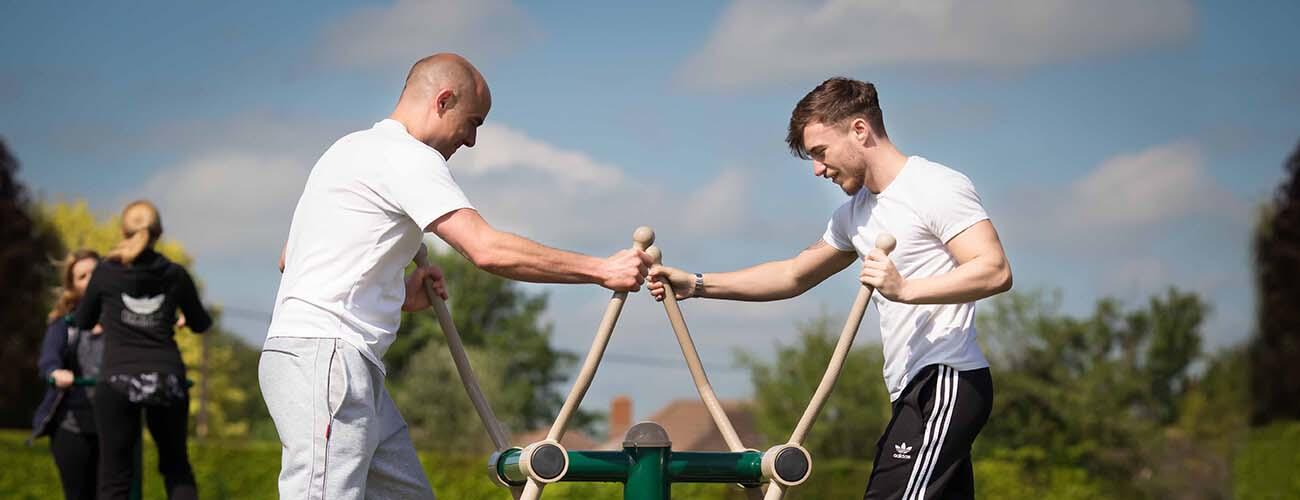 men using outdoor gym equipment, Winchester