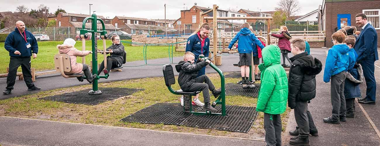 Olympian Rebekah Wilson training class of children to use outdoor gym