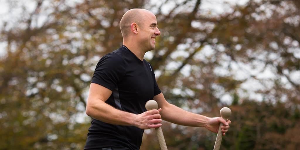man using outdoor gym equipment