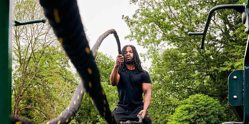 man working out with battle ropes