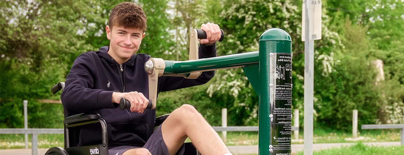 Male using disability gym equipment