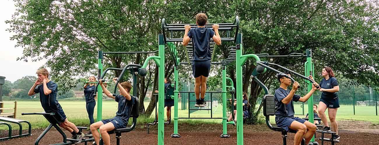 Children on outdoor gym equipment for secondary schools