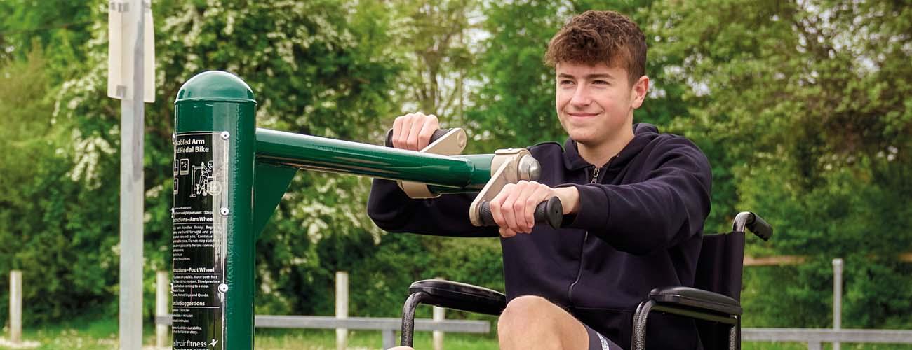 boys using wheelchair accessible outdoor gym