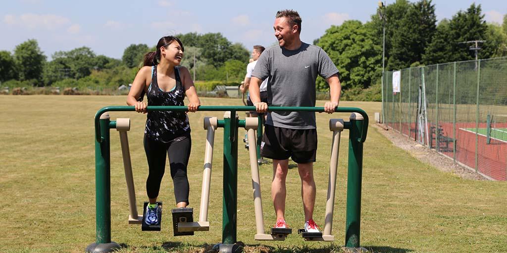 two people using Outdoor gym equipment