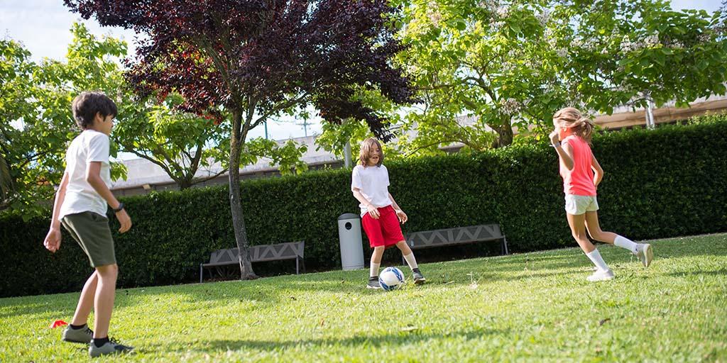 kids playing football in park