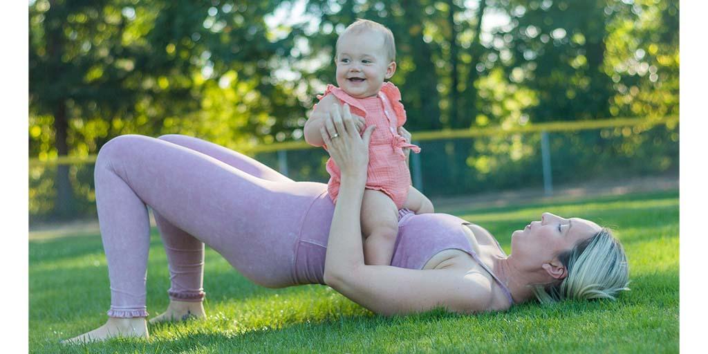 mum exercising in park with baby