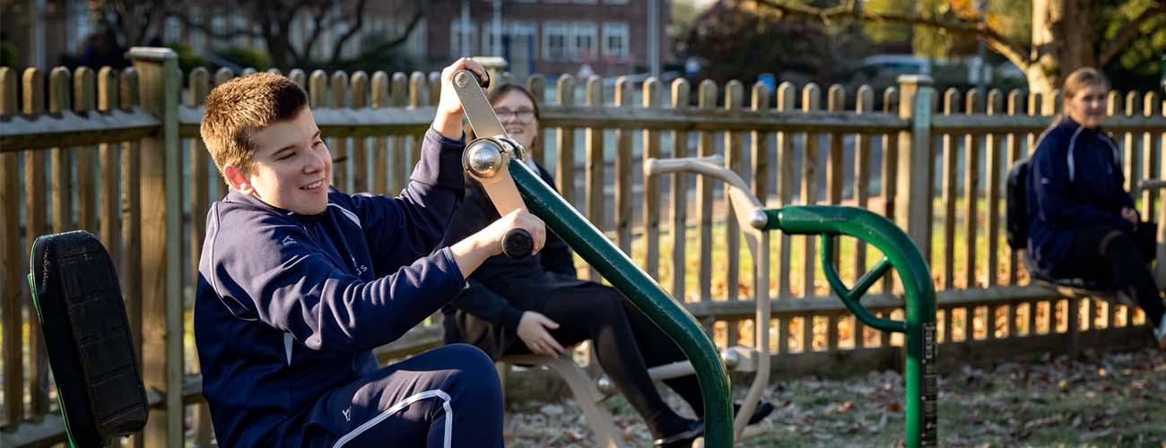 children using Fresh Air Fitness equipment in a SEND school