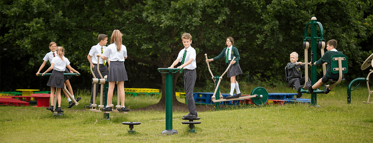 Students using outside gym equipment for junior schools