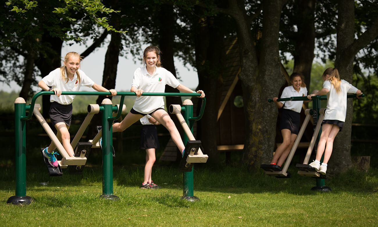girls using outdoor gym