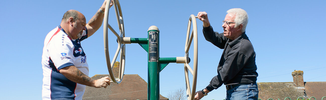Older people exercising on outdoor gym